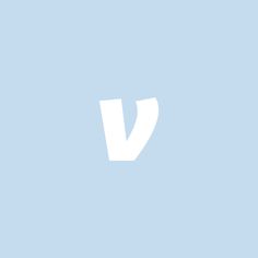 the letter v is white against a light blue background