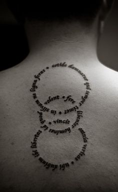 the back of a woman's neck with words written in cursive writing