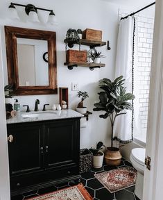 the bathroom is decorated in black and white