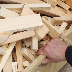 a man is working with wood blocks