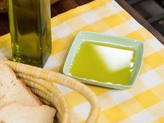 a table with bread and green liquid on it