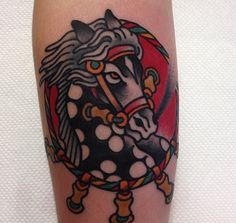 a horse tattoo on the leg of a person's leg, with dots around it