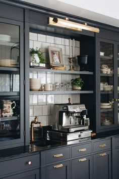 Coffee bar/station bureau. Dark navy cabinets with brass hardware. Glass front cabinets.  Styled with dishes, framed art, and potted houseplants. Kaffe Station, Jean Stoffer, Home Coffee Bar, Coffee Bar Home, Home Bar Designs, Casa Vintage, Black Cabinets, The Coffee, Bars For Home