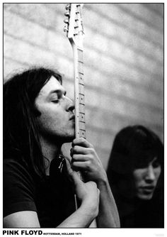 black and white photograph of two people holding an electric guitar