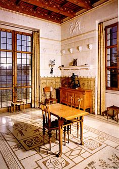 a dining room table and chairs in front of two large windows with wood trimmings