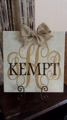 a sign that says kempt on it with a bow hanging from the front of it