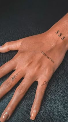 a person's hand with tattoos on it and the word love written in cursive writing