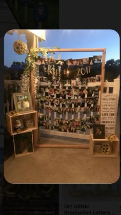 a display with pictures and flowers on it