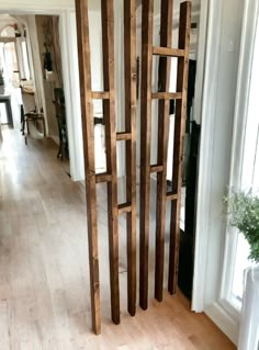 a room divider made out of wooden planks in the middle of a living room