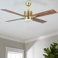 a ceiling fan with wooden blades and a light fixture in a living room area,