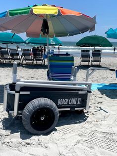 the beach cart is parked on the sand