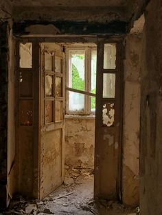 an open door leading into a room with peeling paint