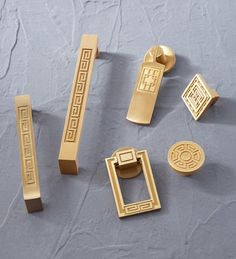 gold door handles and knobs on a gray surface