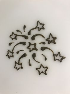 a bunch of chocolate stars sitting on top of a white table