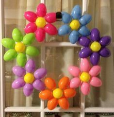 colorful balloons are arranged in the shape of flowers