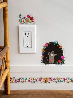 an electrical outlet cover with a mouse on it