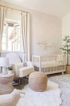 a baby's room with a crib, chair and ottoman