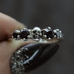 Our beautiful skull wedding ring is set with black spinel either side of one of our tiny anatomical skulls. Originally made by hand and now cast into silver, we size each one of our skull wedding rings by hand to fit you perfectly. ⸸ Metal: Sterling Silver ⸸ Gemstones: Black Spinel ⸸ Weight: approximately 3.5 g