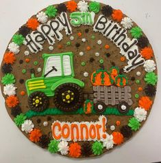 a decorated birthday cake with a tractor on it