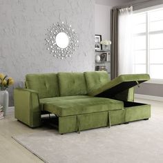 a living room with a green couch and ottoman