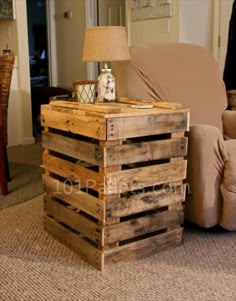 a table made out of wooden pallets with a lamp on top and a couch in the background