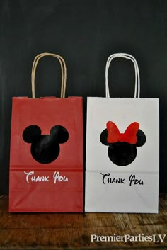 two bags with mickey and minnie mouse heads on them, one has thank you written on it