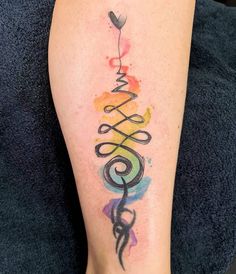 a woman's leg with a tattoo on it that says love and is painted in different colors