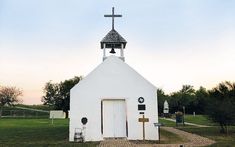 a small white church with a cross on top