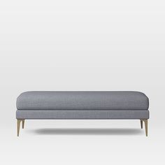 an upholstered bench with wooden legs and a dark blue fabric cover, on a white background