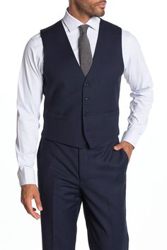 Finish off your look for work when you sport this signature wool vest in a slim cut. Fit: this style fits true to size. Slim fit. V-neck. Sleeveless. Front button closure. Side welt pockets. Back adjustable buckle. Wool construction. Approx. 21.5" length (size M). Imported Business Casual Suits With Notch Lapel And Vest, Business Casual Notch Lapel Suits With Vest, Slim Fit Sleeveless Workwear Vest, Sleeveless Tailoring Vest With Welt Pockets, Sleeveless Suit With Vest For Workwear, Tailored Vest In Suiting Fabric For Business, Tailored Business Vest In Suiting Fabric, Sleeveless Vest Suit For Workwear, Classic Sleeveless Semi-formal Vest