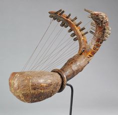 an old wooden instrument with metal strings attached to it