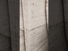 three different angles of the same wall with concrete blocks in front of it and one on the other side