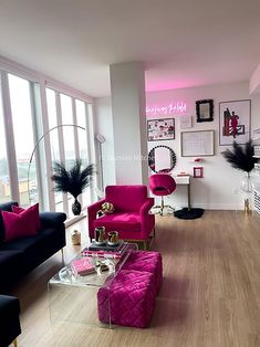 a living room filled with furniture and lots of windows