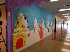 a school hallway decorated in bright colors with the word welcome written on it and children's artwork