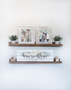 two wooden shelves with pictures and plants on them, one holding a couple's wedding photos