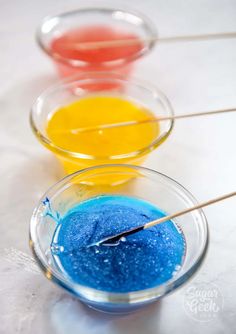 three bowls filled with different colored liquids