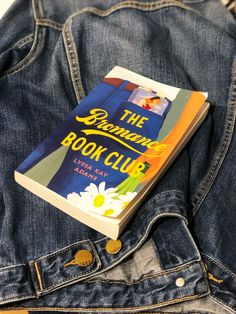 a book sitting in the back pocket of a pair of blue jean pants that are open