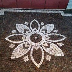 a white and brown mosaic on the ground