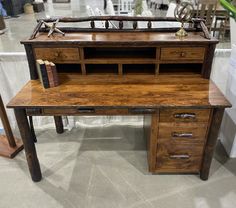 a wooden desk with two drawers and a book shelf on top of it in a store