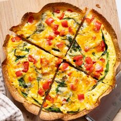 a pizza cut into eight slices on top of a cutting board next to a knife