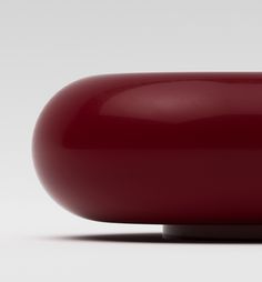 a red object sitting on top of a white surface