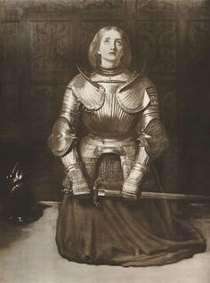 an old black and white photo of a woman in armor