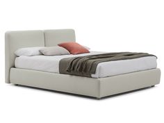 a bed with a white headboard and two pillows on it's sides, in front of a white background