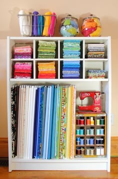 a white bookcase filled with lots of books