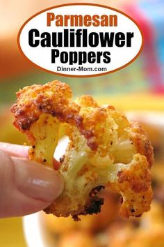 a hand holding up a piece of cauliflower with the words parmesan cauliflower poppers above it