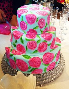 a three tiered cake with pink roses on it