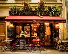 the outside of a restaurant with tables and chairs