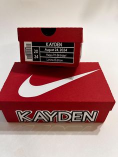 a red box with a white nike logo on it and the name kayden printed on it