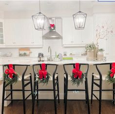 a kitchen filled with lots of counter top space and christmas decorations on the bar stools