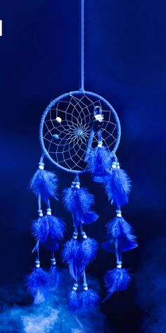 a blue dream catcher hanging from a string